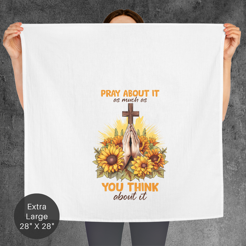 Person holding a towel with a cross, hands in prayer, and sunflowers design on a gray background.