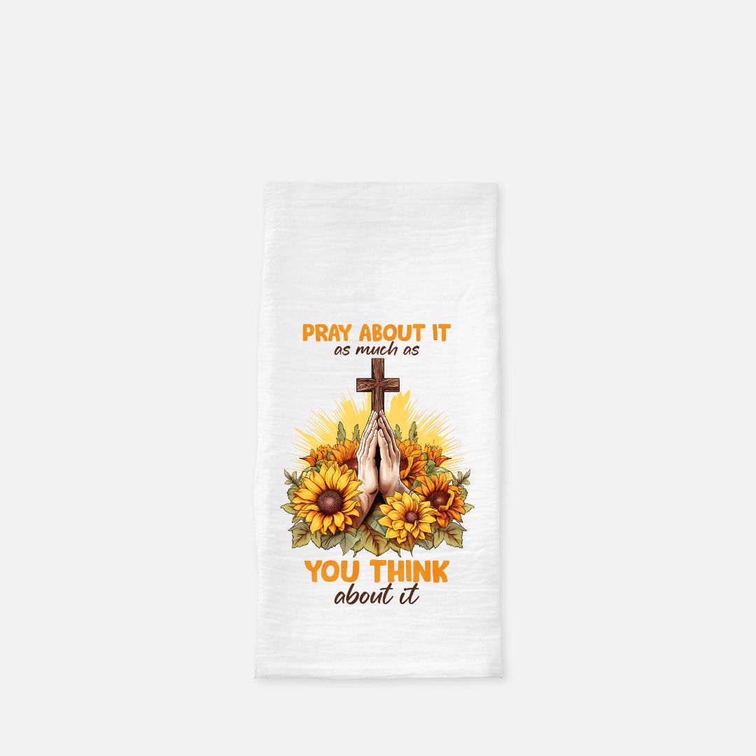 White towel with sunflower design, cross, and praying hands on a white background