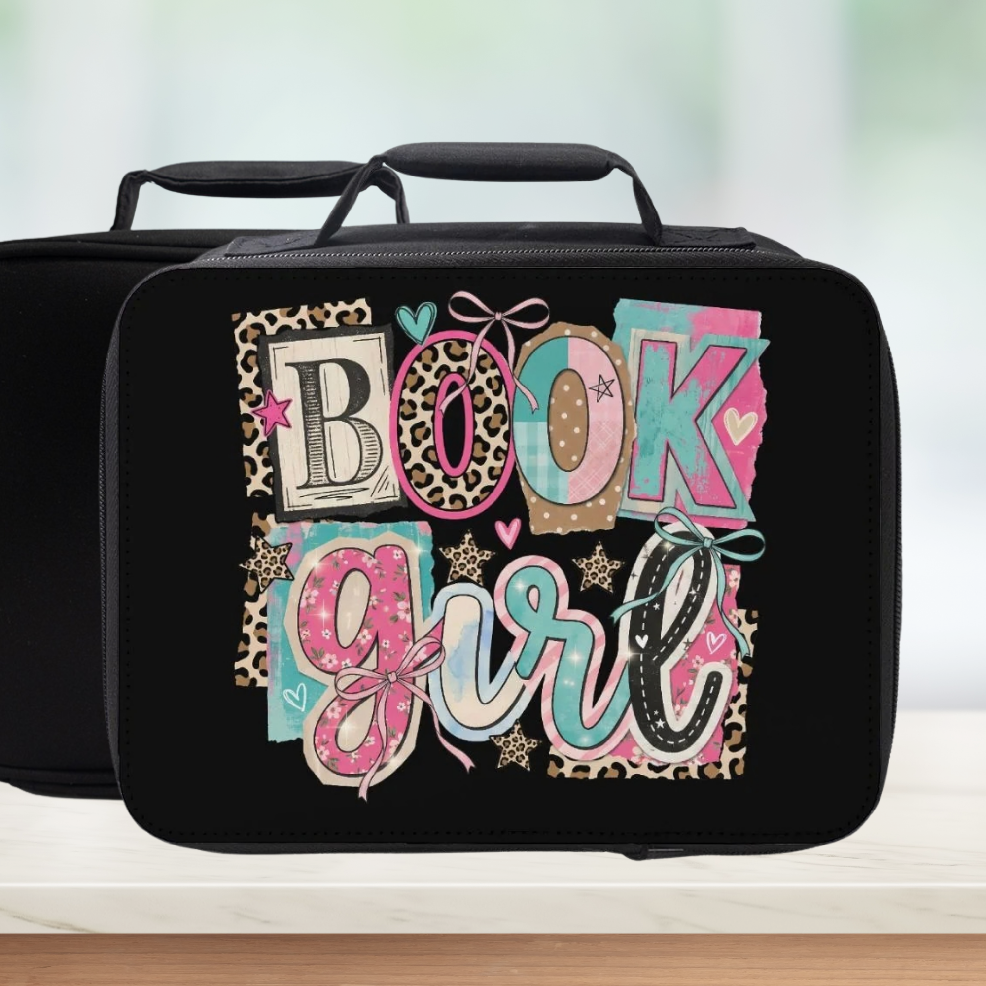 Black lunch bag with colorful 'BOOK girl' text design on a light background
