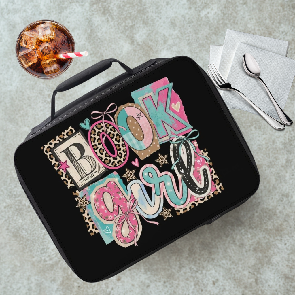 Black lunch bag with a colorful 'Book Girl' design on a gray table with a drink and utensils.