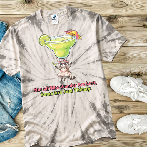 Spider Silver Tie-dye t-shirt with a graphic of a margarita parachute, raccoon, and text on a wooden surface.