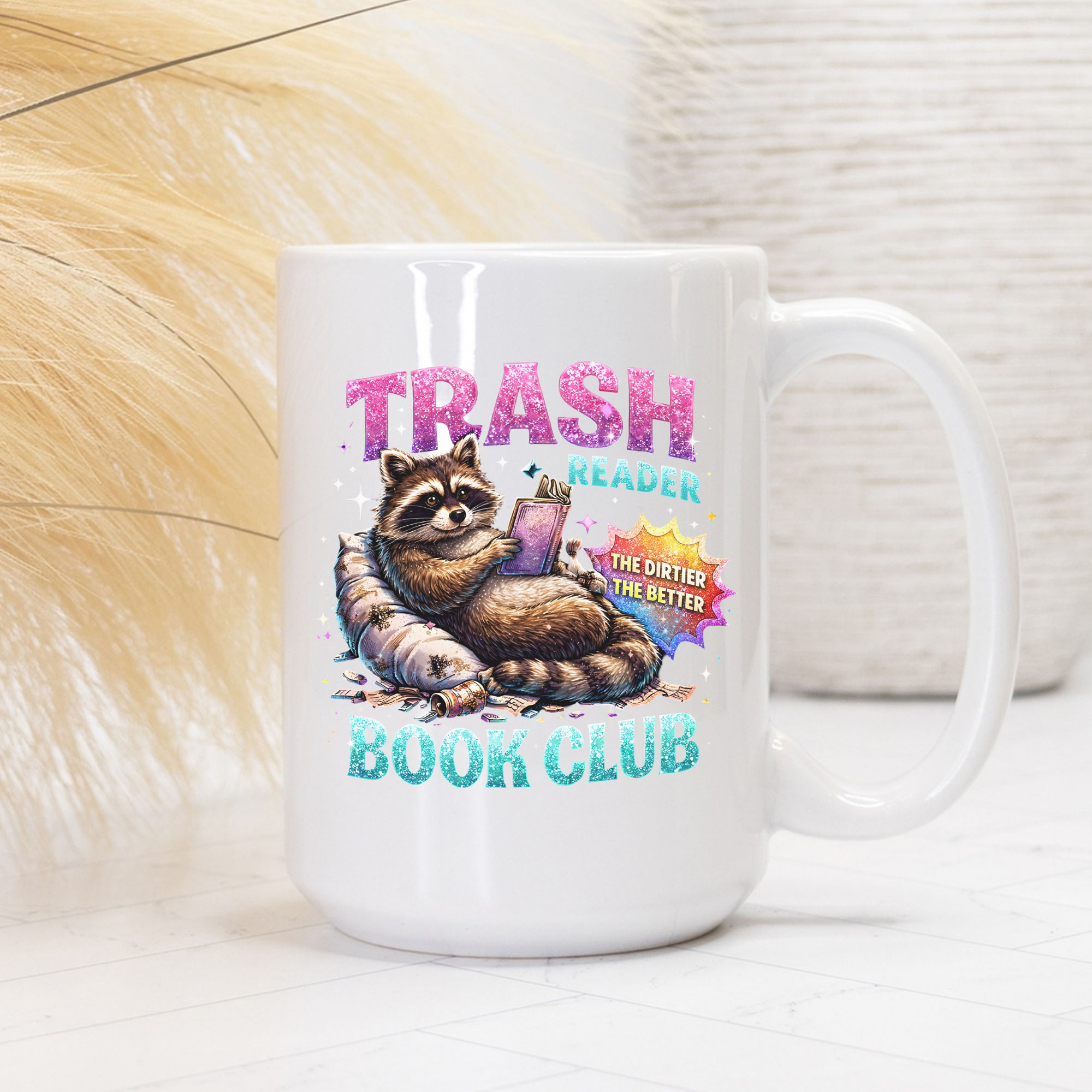White mug with a raccoon graphic and text 'Trash Reader Book Club' on a light background