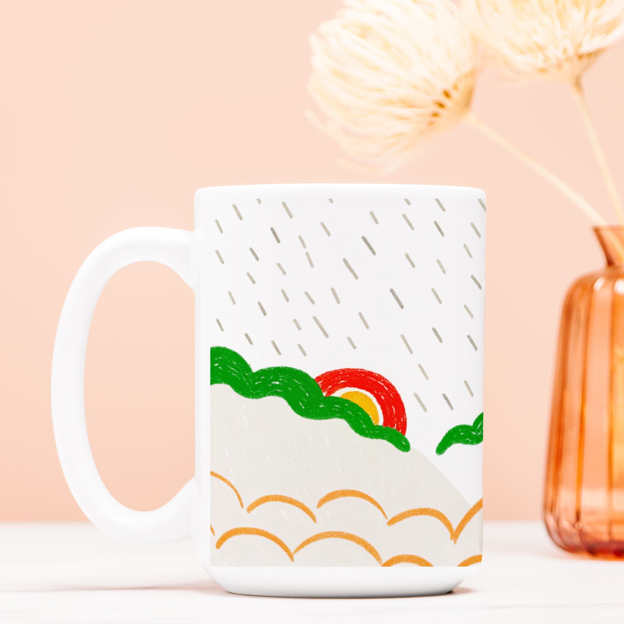 White mug with a colorful design of a rainbow and mountains on a light pink background.