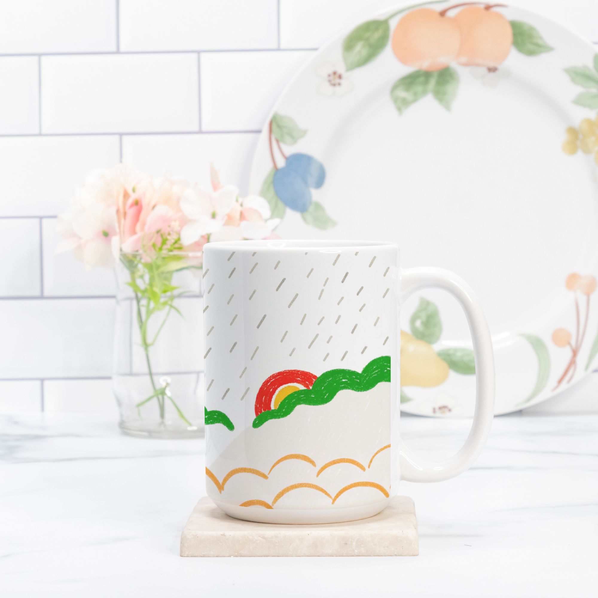White mug with colorful design on a white surface with a blurred background