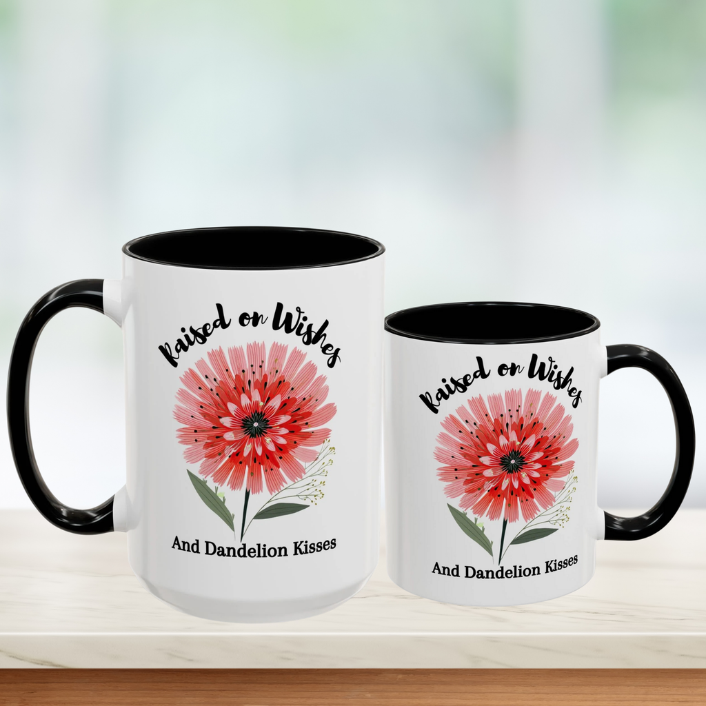 Two white mugs (11oz & 15oz) with black handles featuring a red flower design and text on a blurred background.
