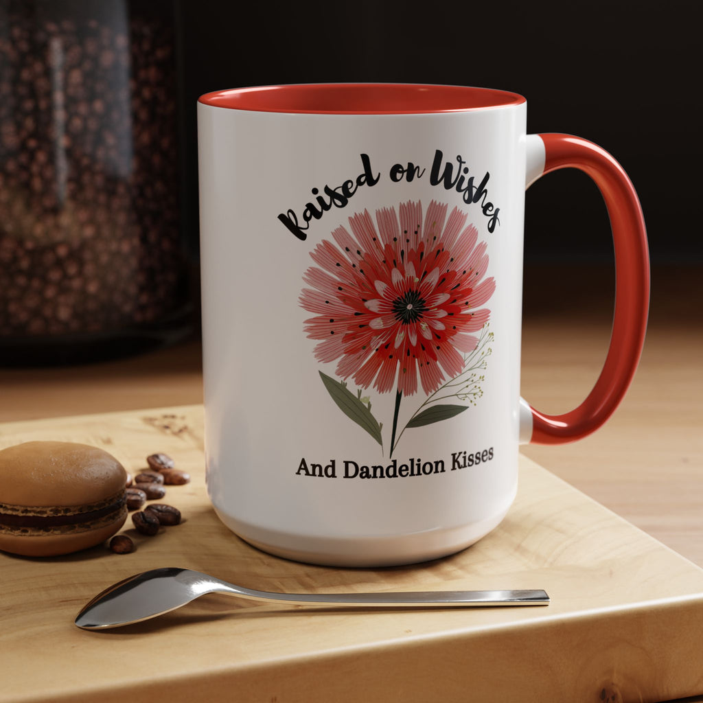 Red accent mug with floral design and text on a wooden surface with coffee beans and a spoon.