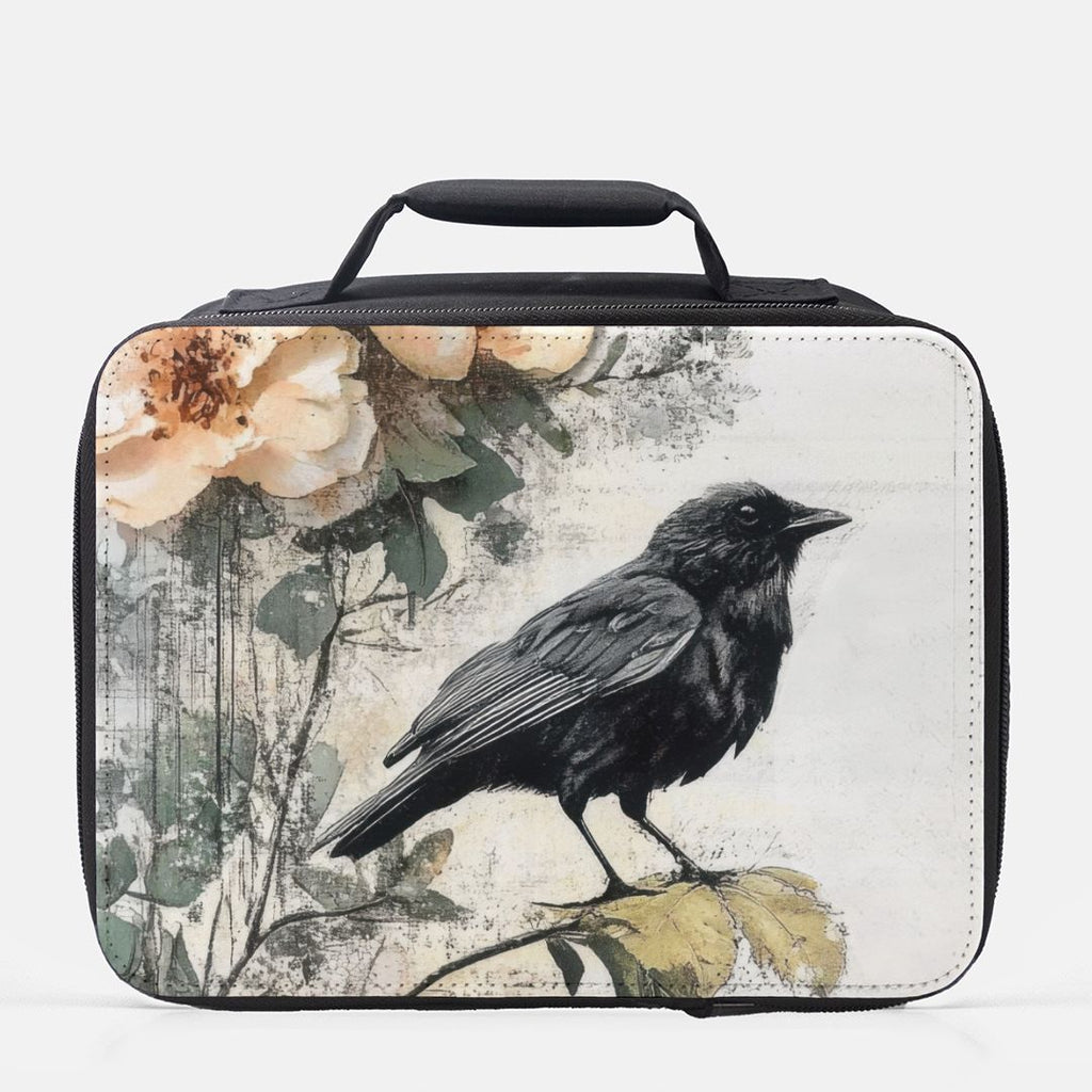 Black bird and floral design on a rectangular lunch bag with a handle.