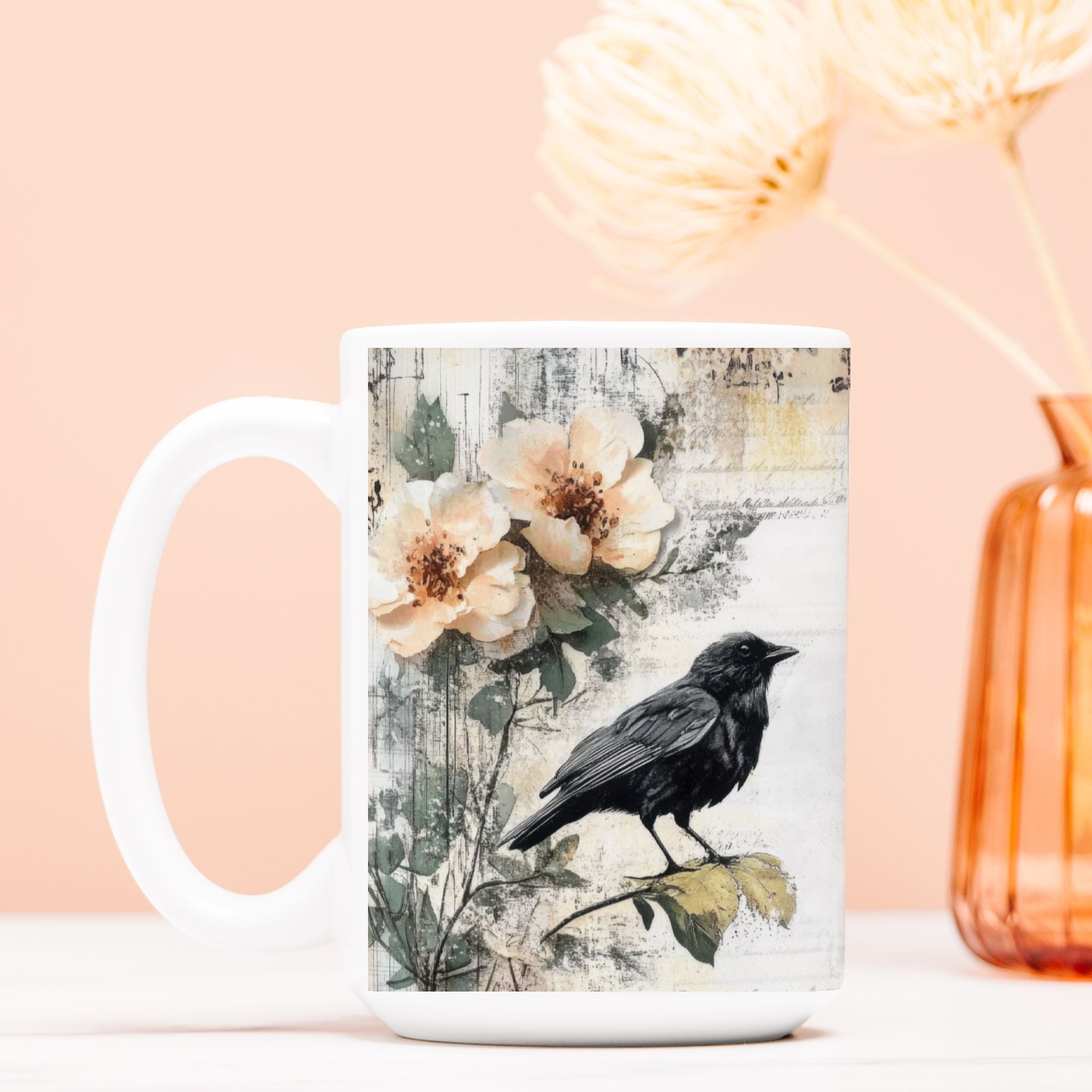 White mug with a black crow and floral design on a peach background