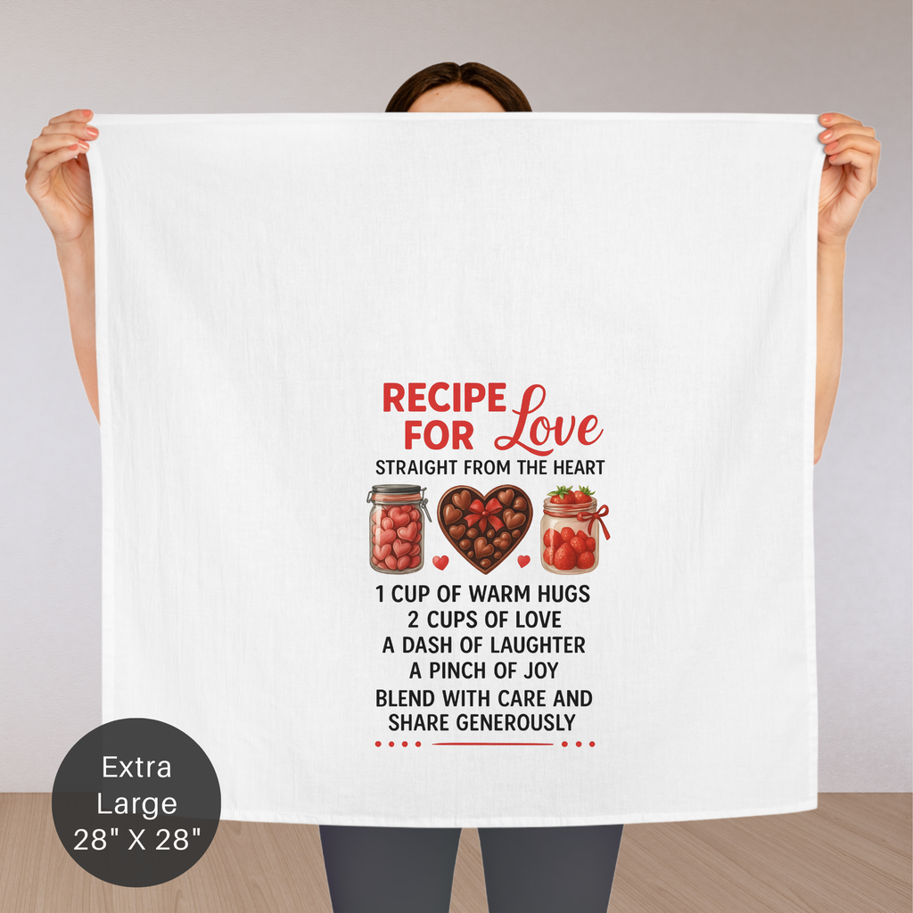 Person holding an extra large tea towel with 'Recipe for Love' text and graphics.