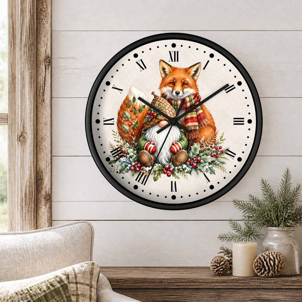 A round wall clock with a black frame and a festive illustration of a fox wrapped in a red and green striped scarf, surrounded by holiday greenery and ornaments, mounted on a white wood-paneled wall above a wooden table with decorative plants and candles.