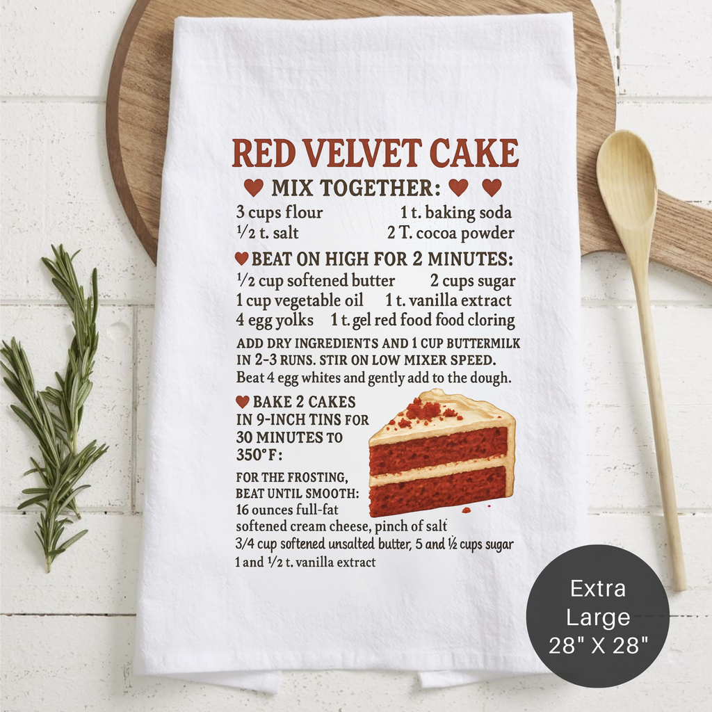 Red velvet cake recipe towel with a slice of cake graphic on a wooden board.
