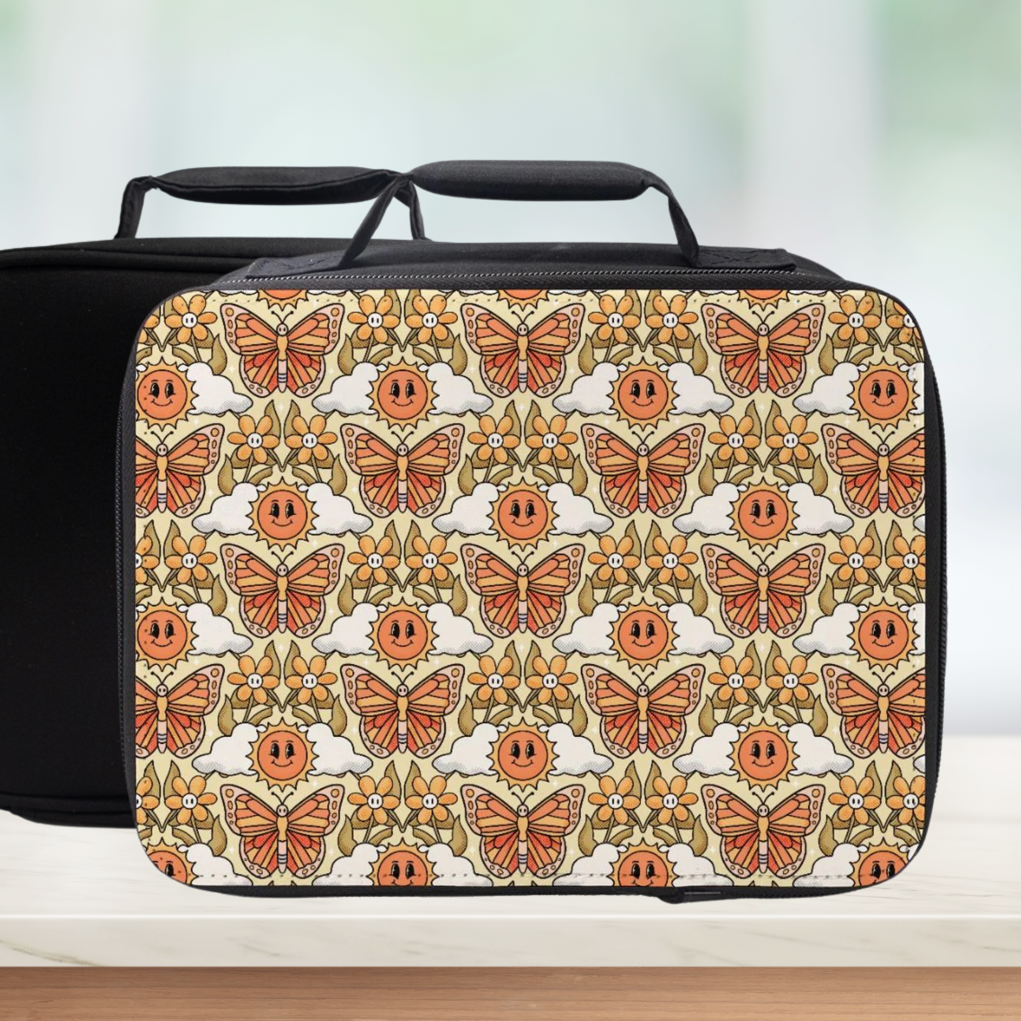 Black rectangular lunch bag with a butterfly and sun pattern on a white background