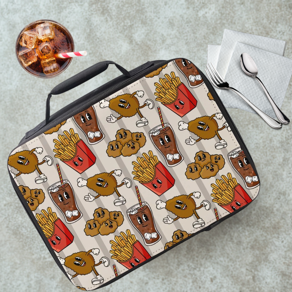 Lunch bag with cartoon food pattern on a cafeteria table with a drink and utensils.