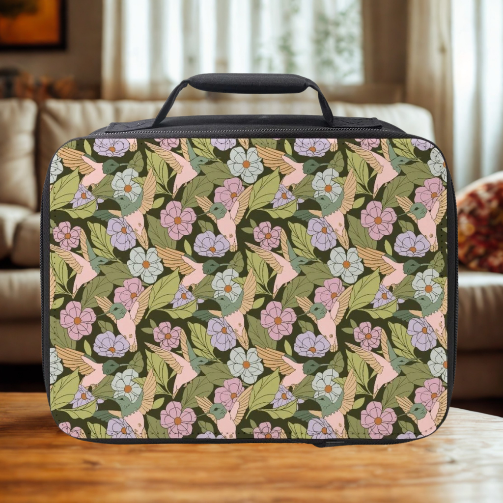 Floral and bird patterned lunch bag on a wooden surface with a blurred indoor background
