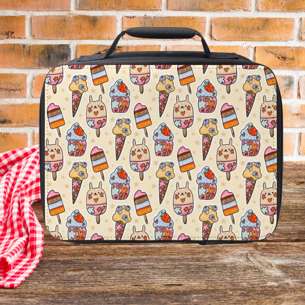 insulated lunch bag with ice cream pattern on a wooden picnic table and brick wall background
