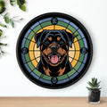 Wall clock with a Rottweiler design on a white wall with a plant and small pot.