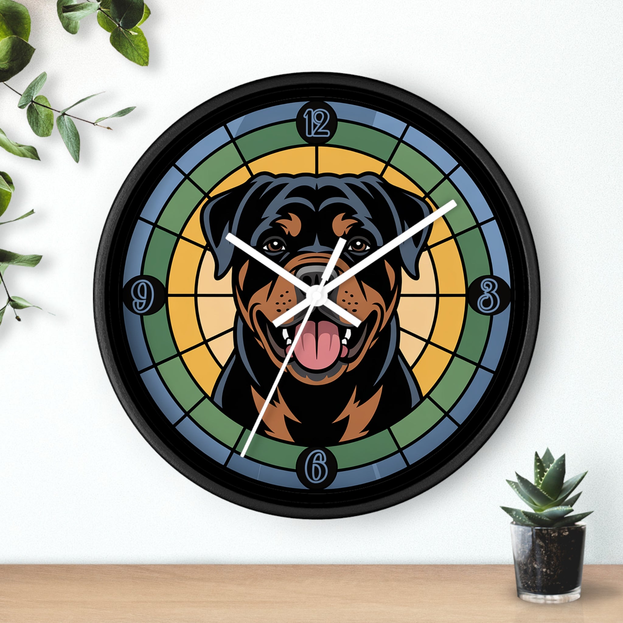 Wall clock with a Rottweiler design on a white wall with a plant and small pot.