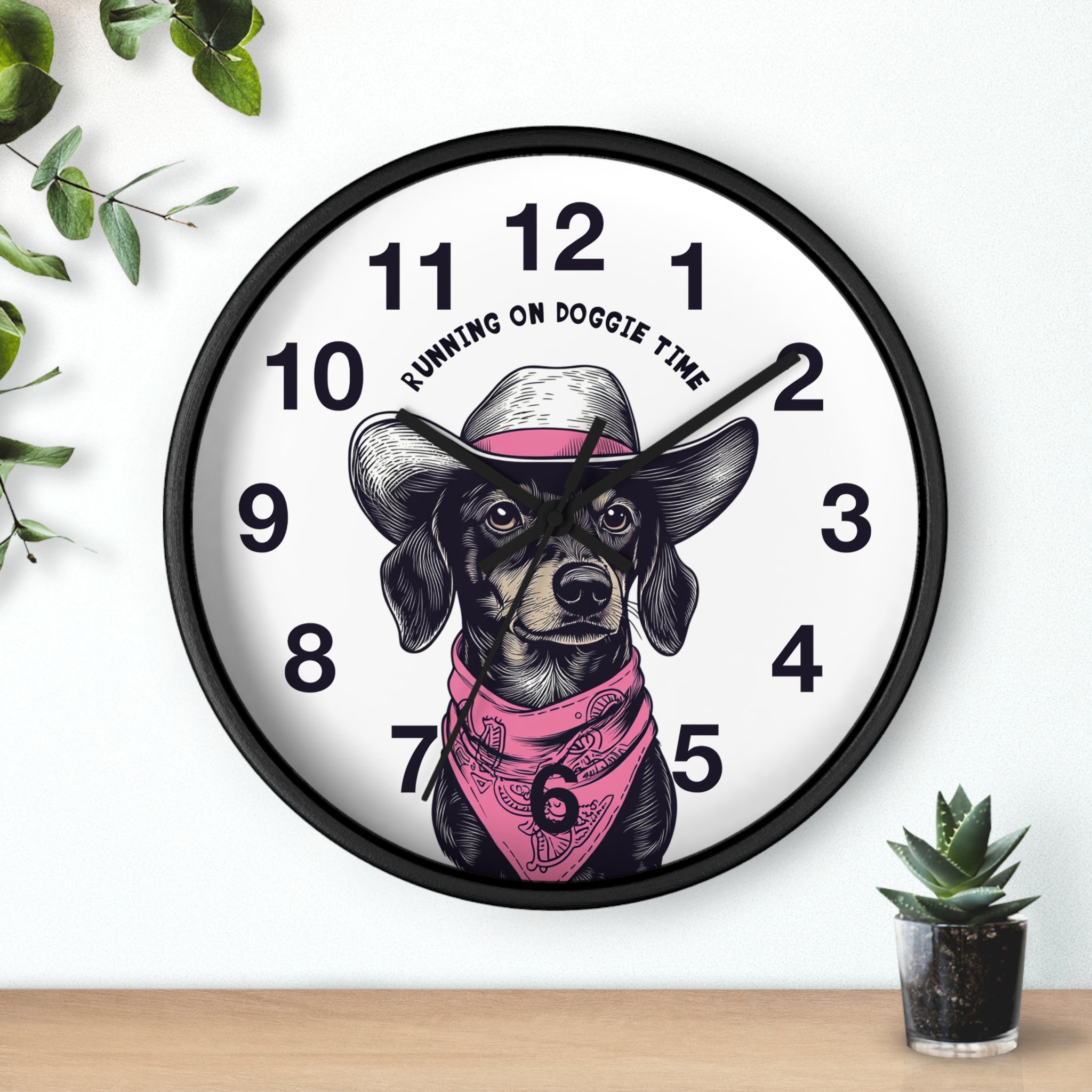 Wall clock with a dog illustration and 'Running on Doggie Time' text, placed on a surface with plants.