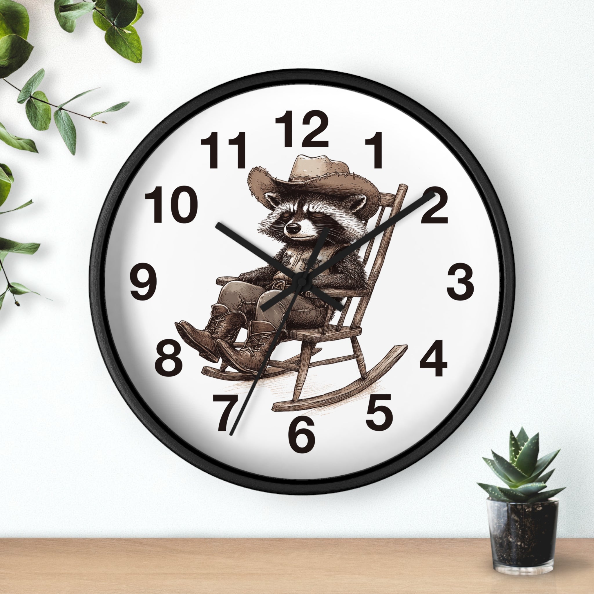 Round black wall clock with a raccoon in a cowboy hat design on a white background