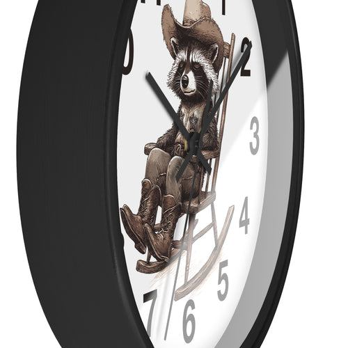 Side view of a round black wall clock with a raccoon wearing a cowboy hat and boots design on a white background