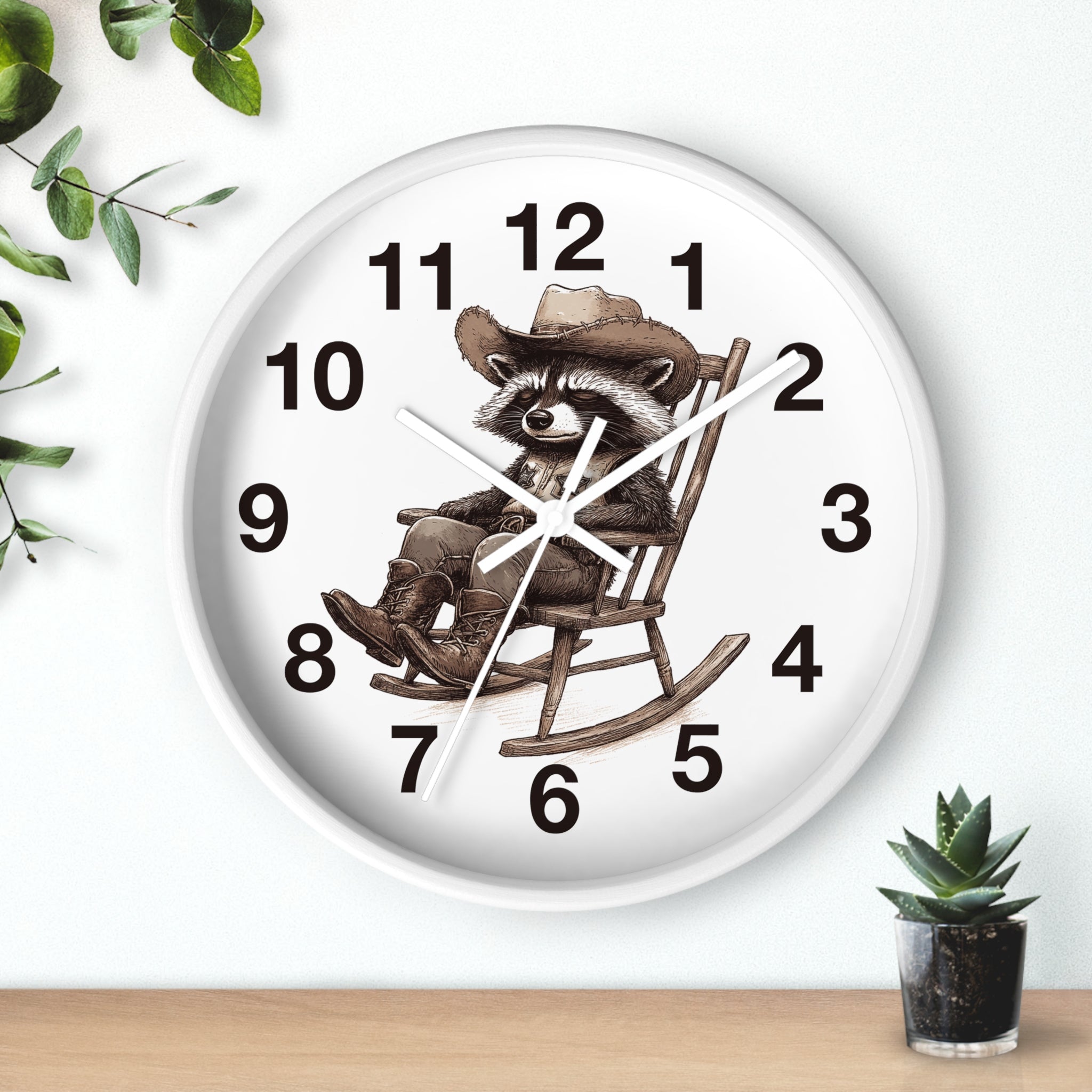 Round white wall clock with a raccoon in a cowboy hat and rocking chair design on a white background.