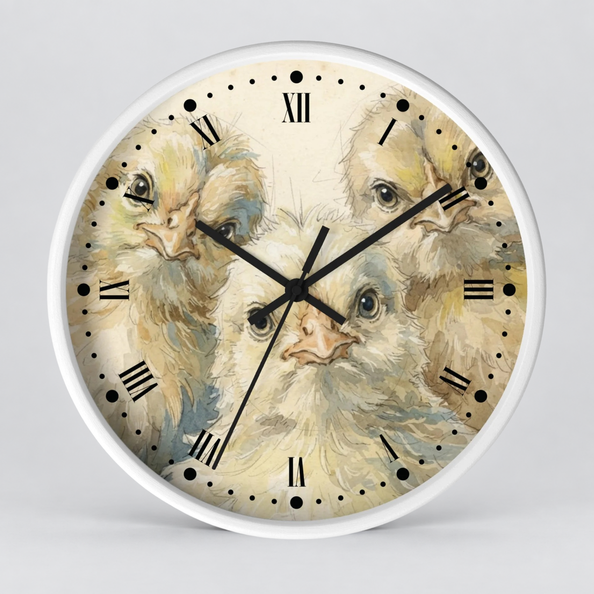 Round wall clock with a white frame and a printed dial featuring three fluffy chicks in soft cream, beige, and light blue tones, with black Roman numerals and black clock hands on a light gray background.