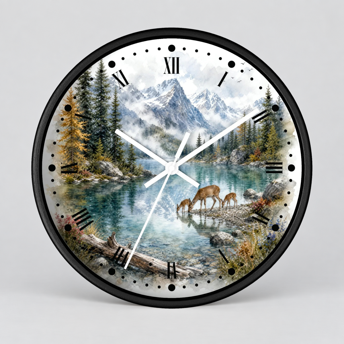 A round wall clock with a black frame and a scenic nature print featuring a mountain lake, evergreen trees, and deer, shown on a light gray background.
