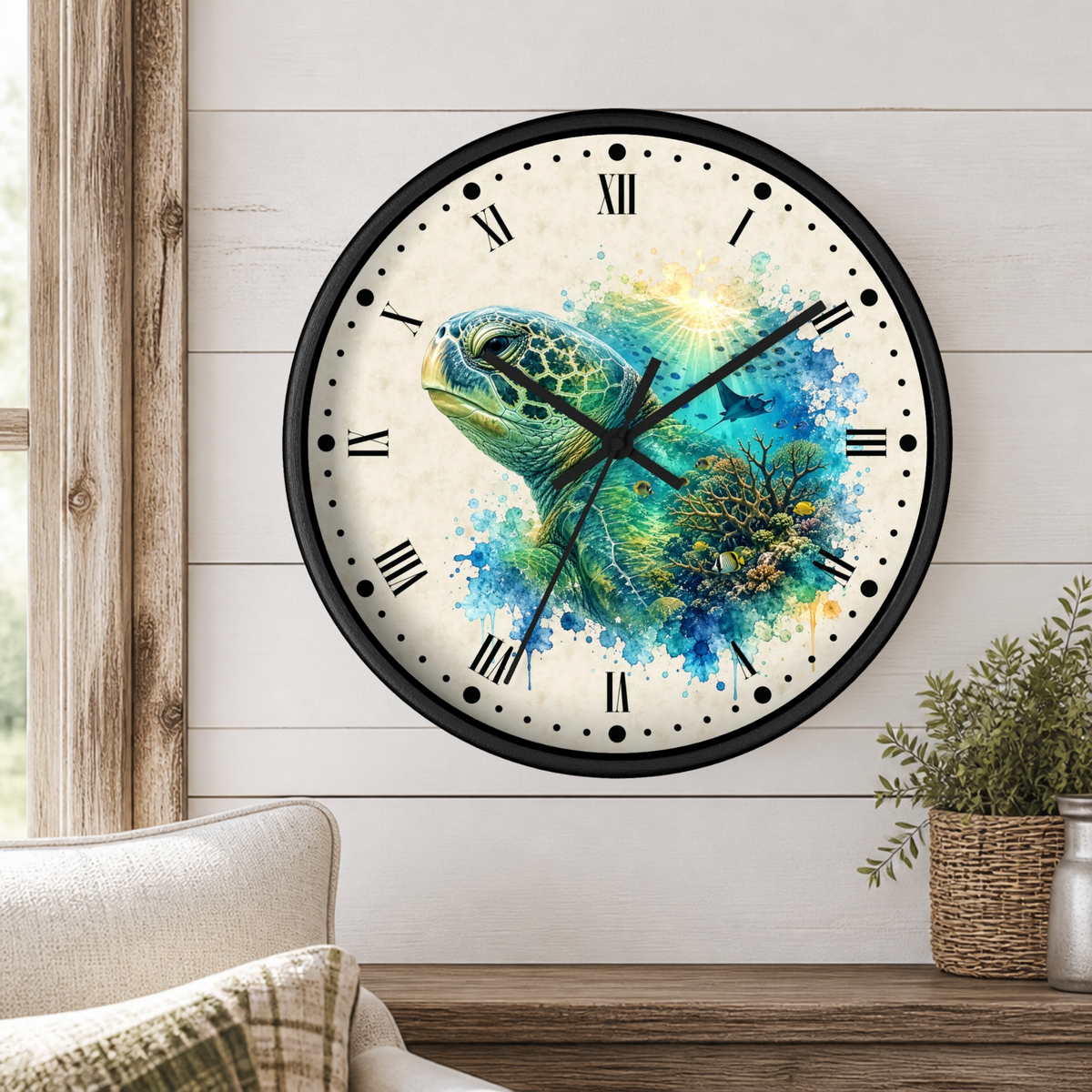 A round wall clock with a black frame and a watercolor-style turtle design in blue, green, and yellow tones on a light background. The clock is mounted on a white wood-paneled wall above a wooden shelf with a small potted plant and part of a sofa visible.