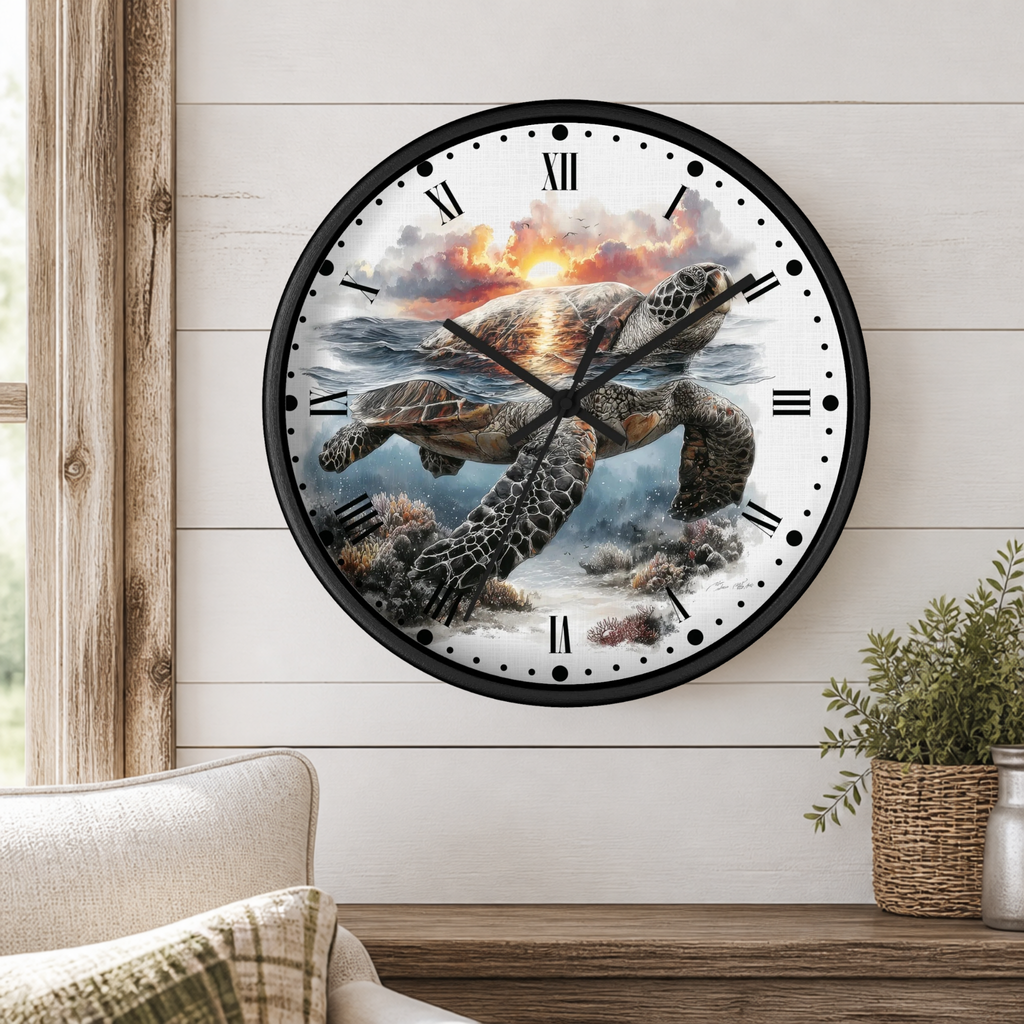 A round wall clock with a black frame and a printed design of a sea turtle swimming in ocean water under a sunset sky, mounted on a white wood-paneled wall above a wooden shelf with a plant and part of a sofa visible.