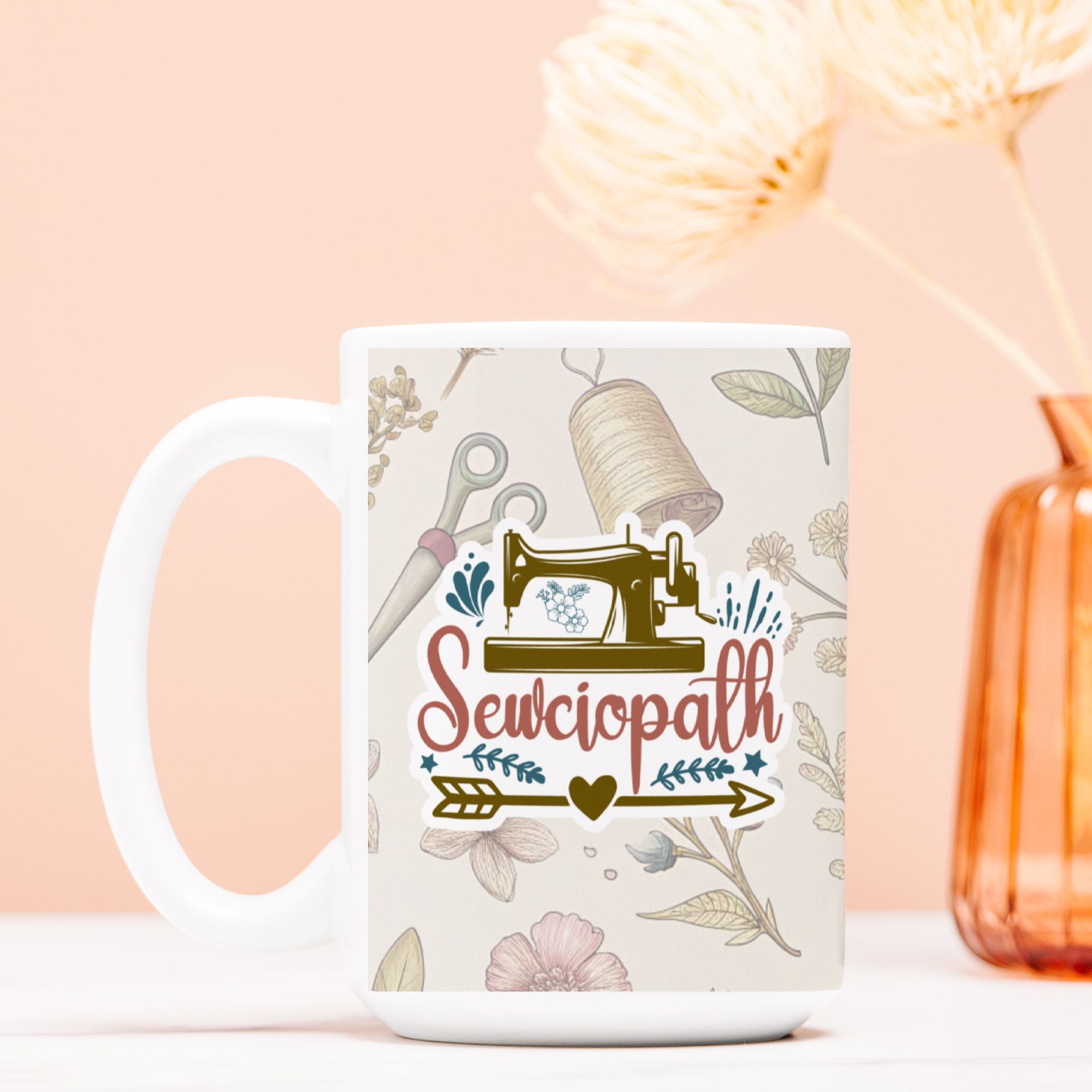 White mug with sewing-themed design and 'Sewciopath' text on a light pink background