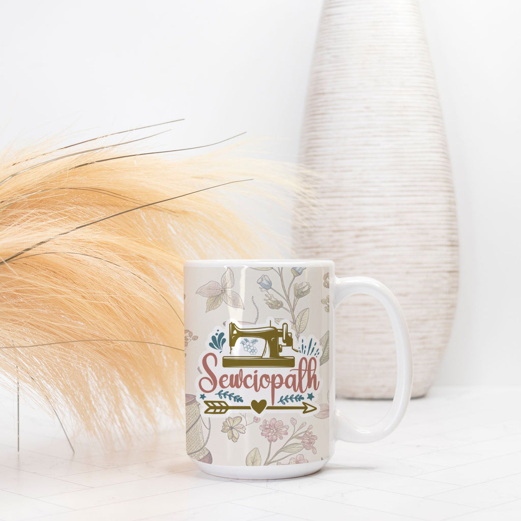 Mug with 'Sewciopath' design on a white surface with decorative elements