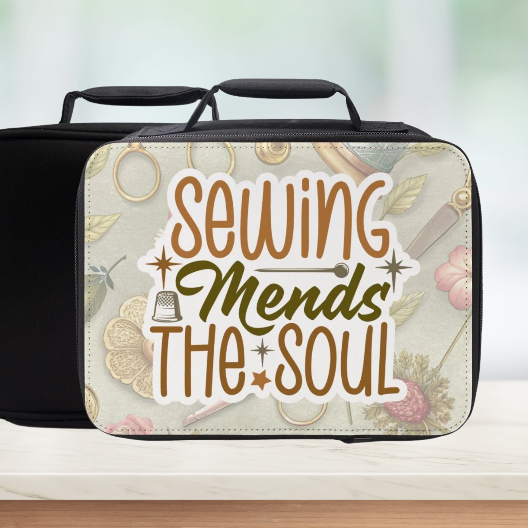 Insulated lunch bag with 'Sewing Mends The Soul' sticker style text and floral sewing themed pattern on a blurred background