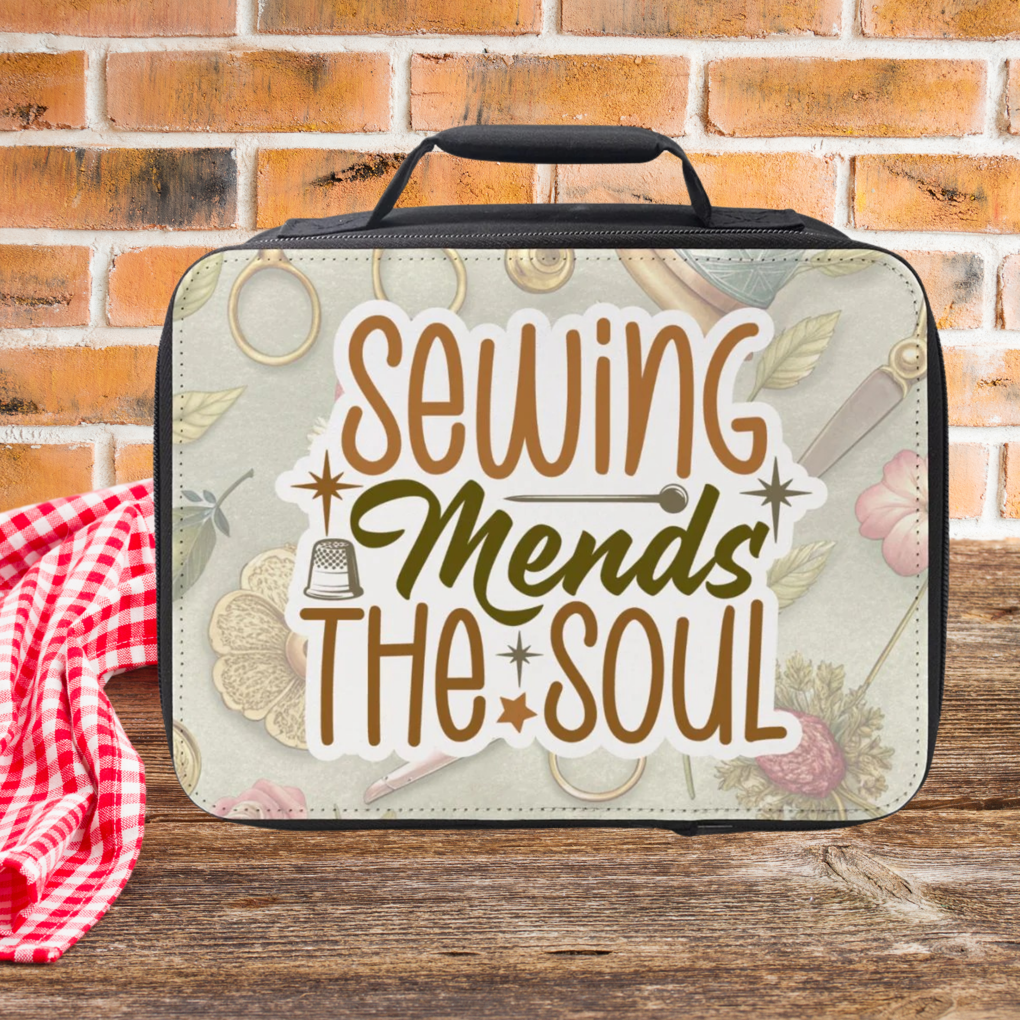 Insulated lunch bag with 'Sewing Mends The Soul' text on a wooden picnic table against a  brick wall background