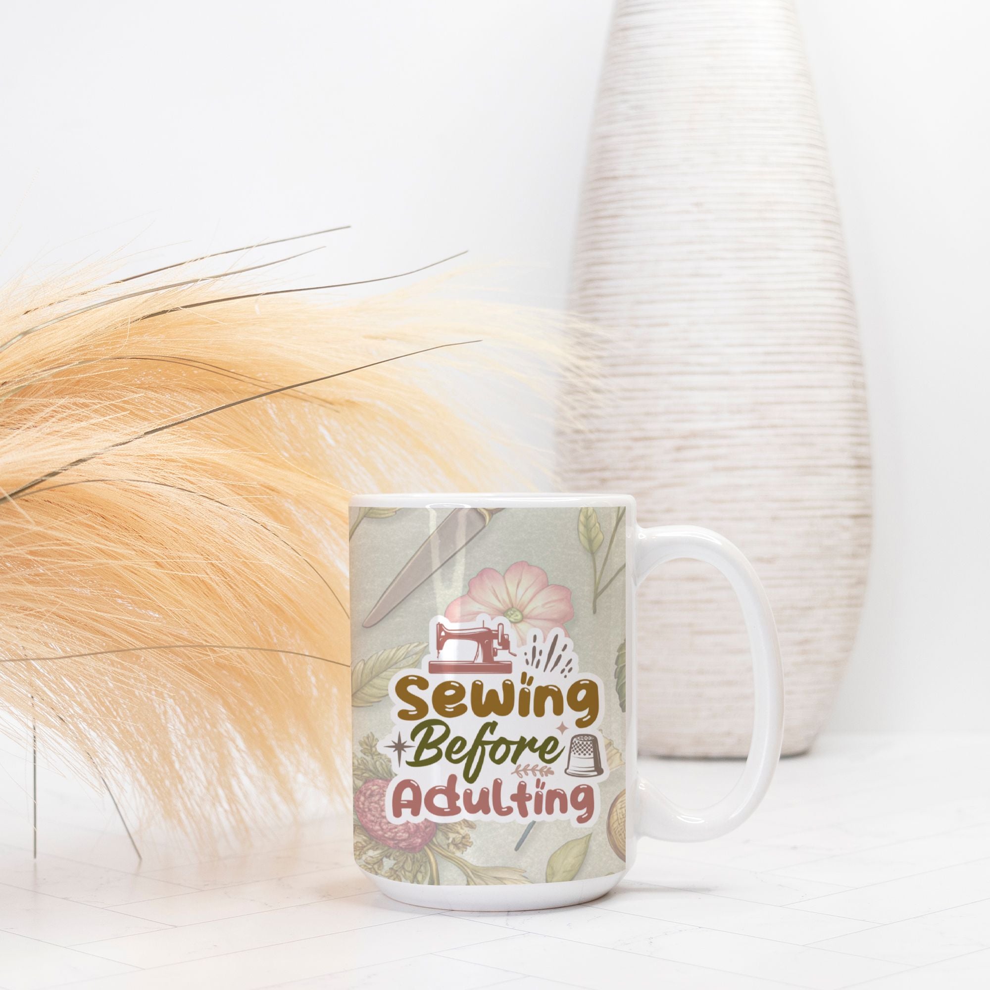 Mug with 'Sewing Before Adulting' design on a white surface with decorative elements.