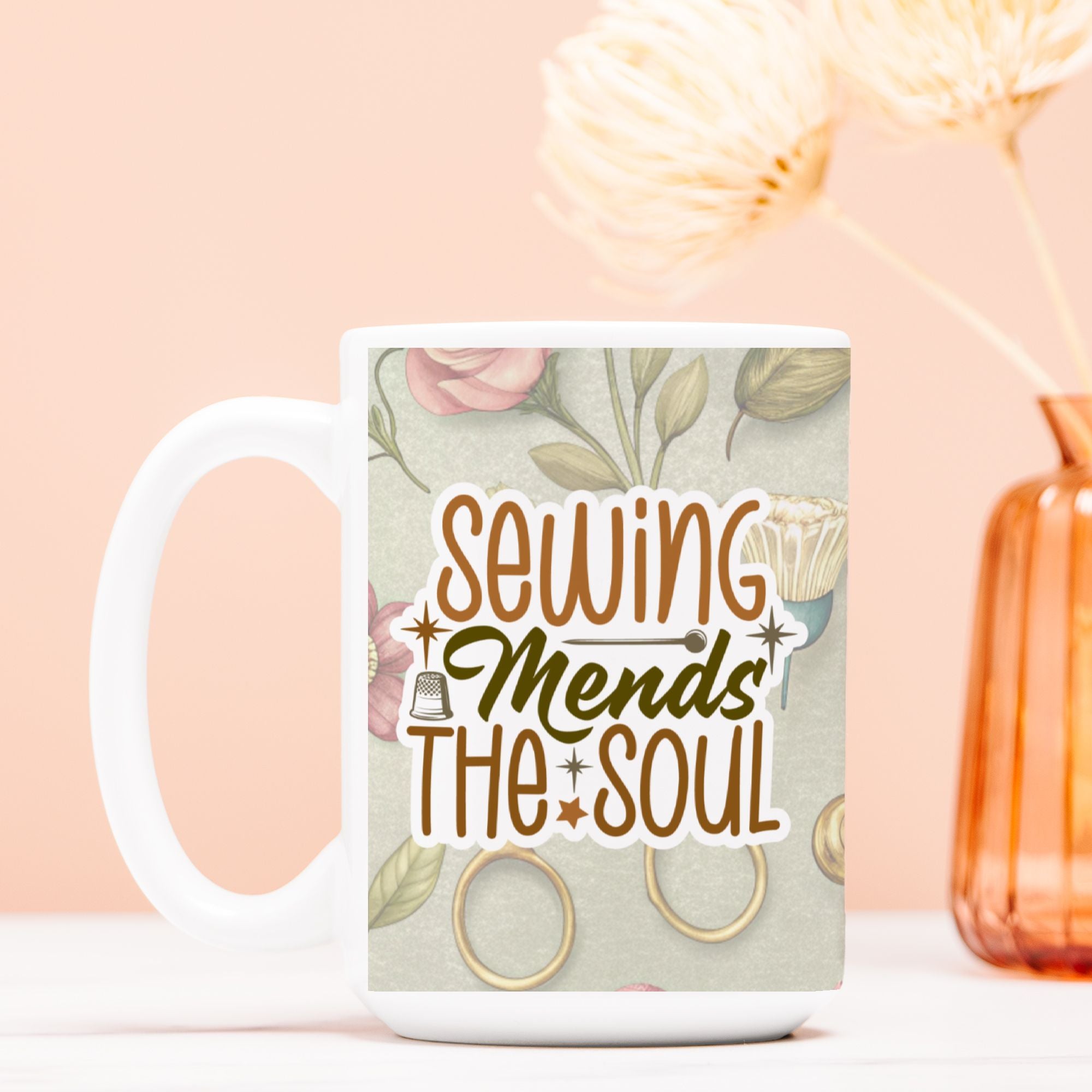 Mug with 'Sewing Mends The Soul' text and floral design on a light pink background