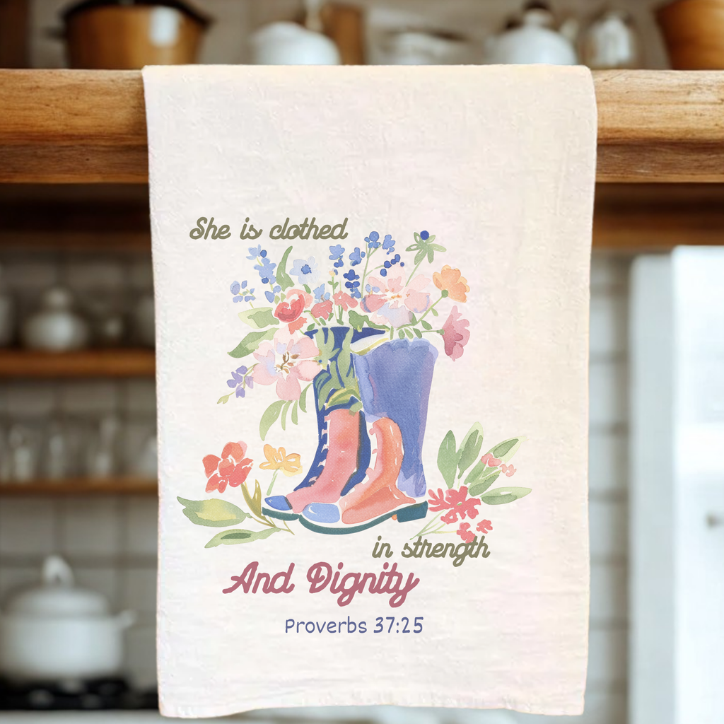 Decorative tea towel with floral design and text on a kitchen towel rack.