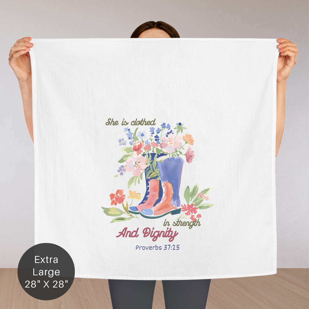 Person holding an extra large towel with floral design and text on a plain background