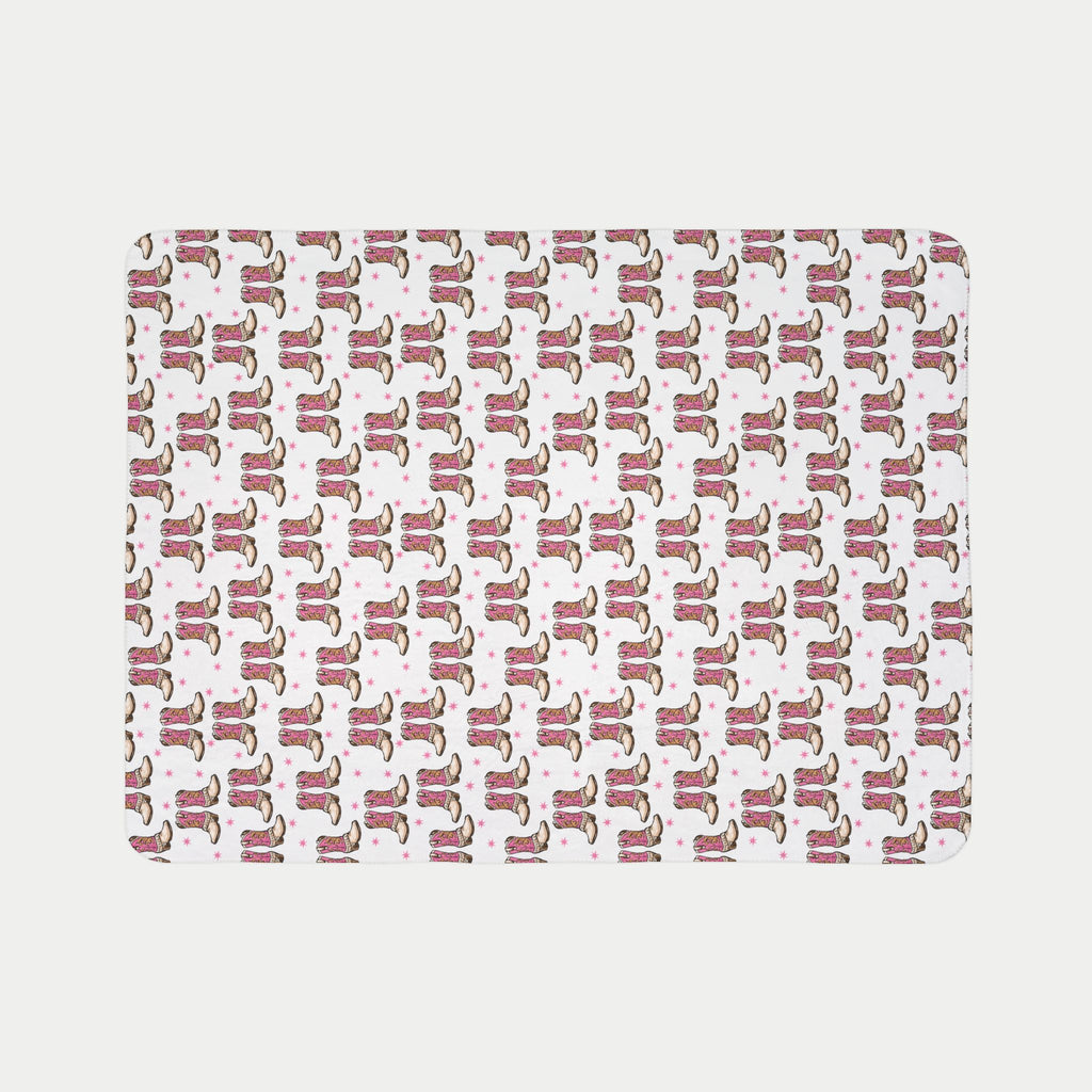 Pattern of cowboy boots on a pink background