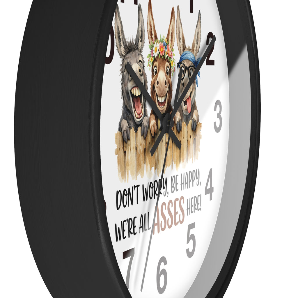 Wall clock with cartoon donkeys and humorous text on a white background