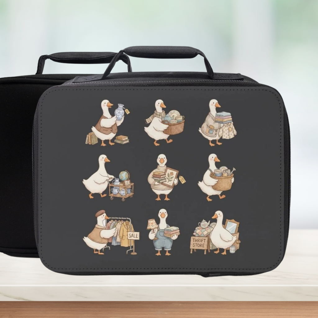 Black lunch bag with illustrated thrift shopping geese on a gray background