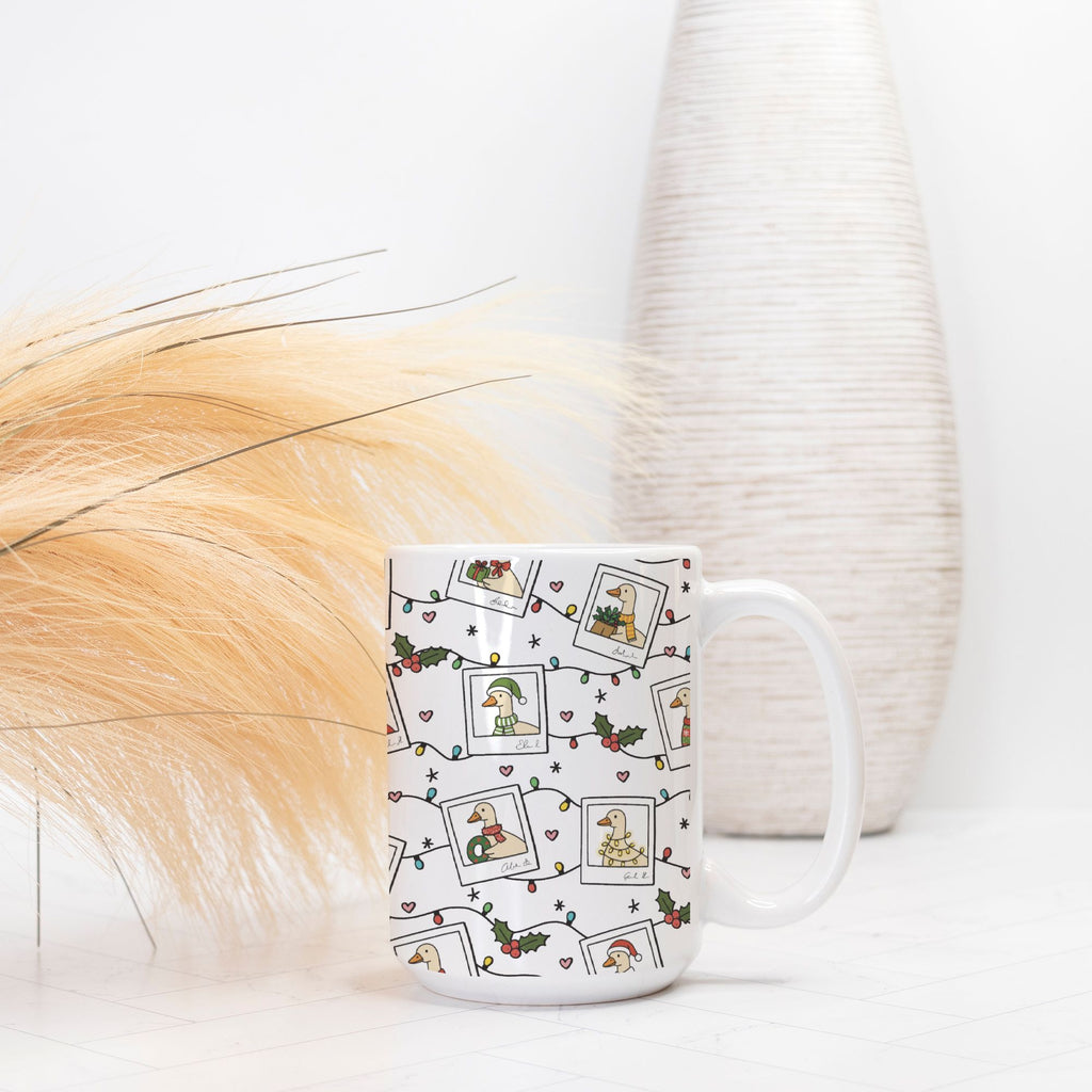 White mug with festive design featuring Santa Geese, holly leaves, and berries on a white background.