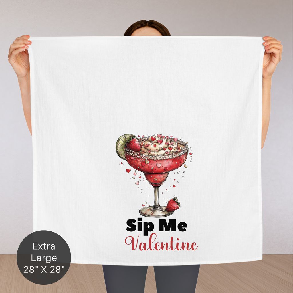Person holding an extra large tea towel with a Valentine's Day-themed design of a red cocktail.