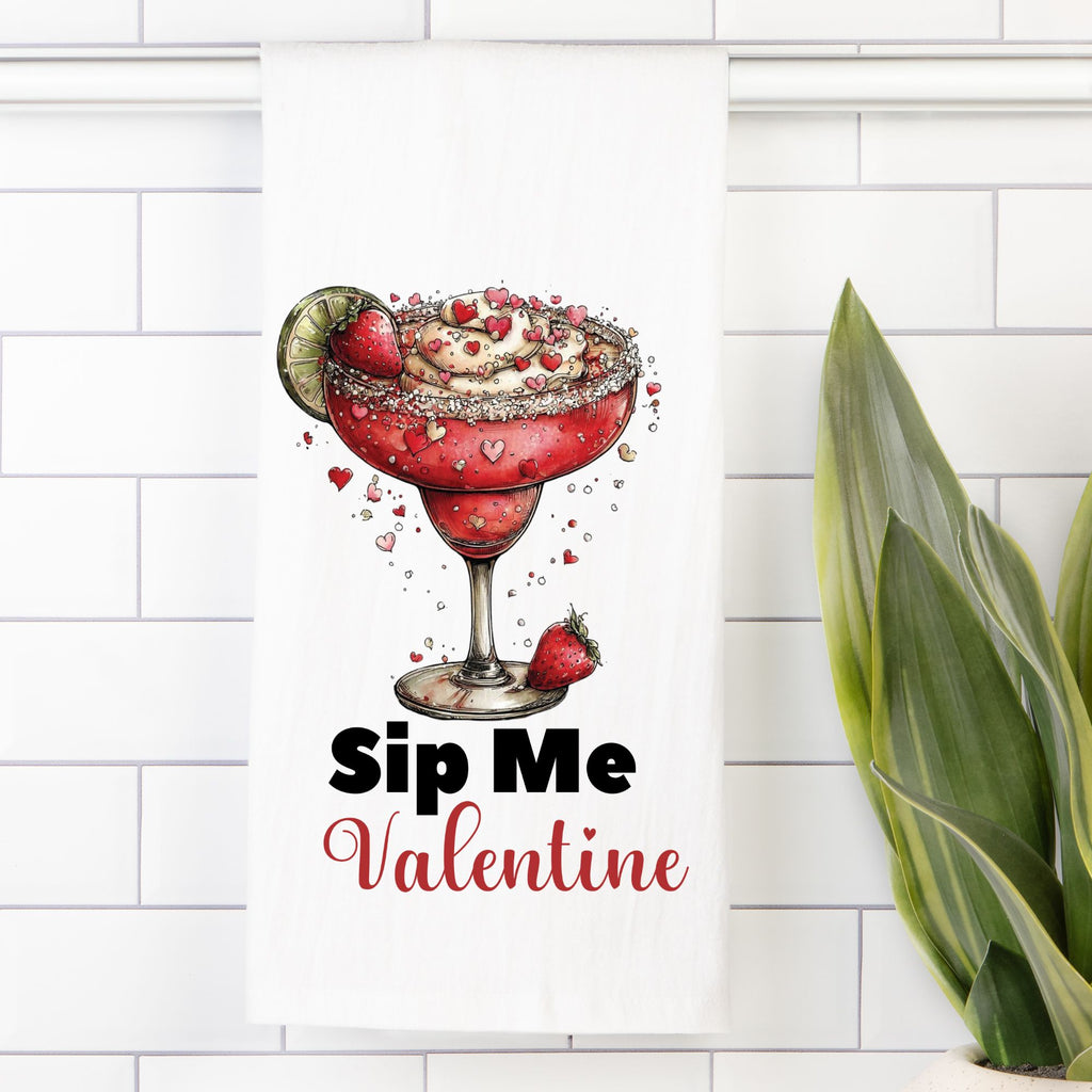 Tea towel with a red cocktail with garnishes on a white tile background with 'Sip Me Valentine' text.