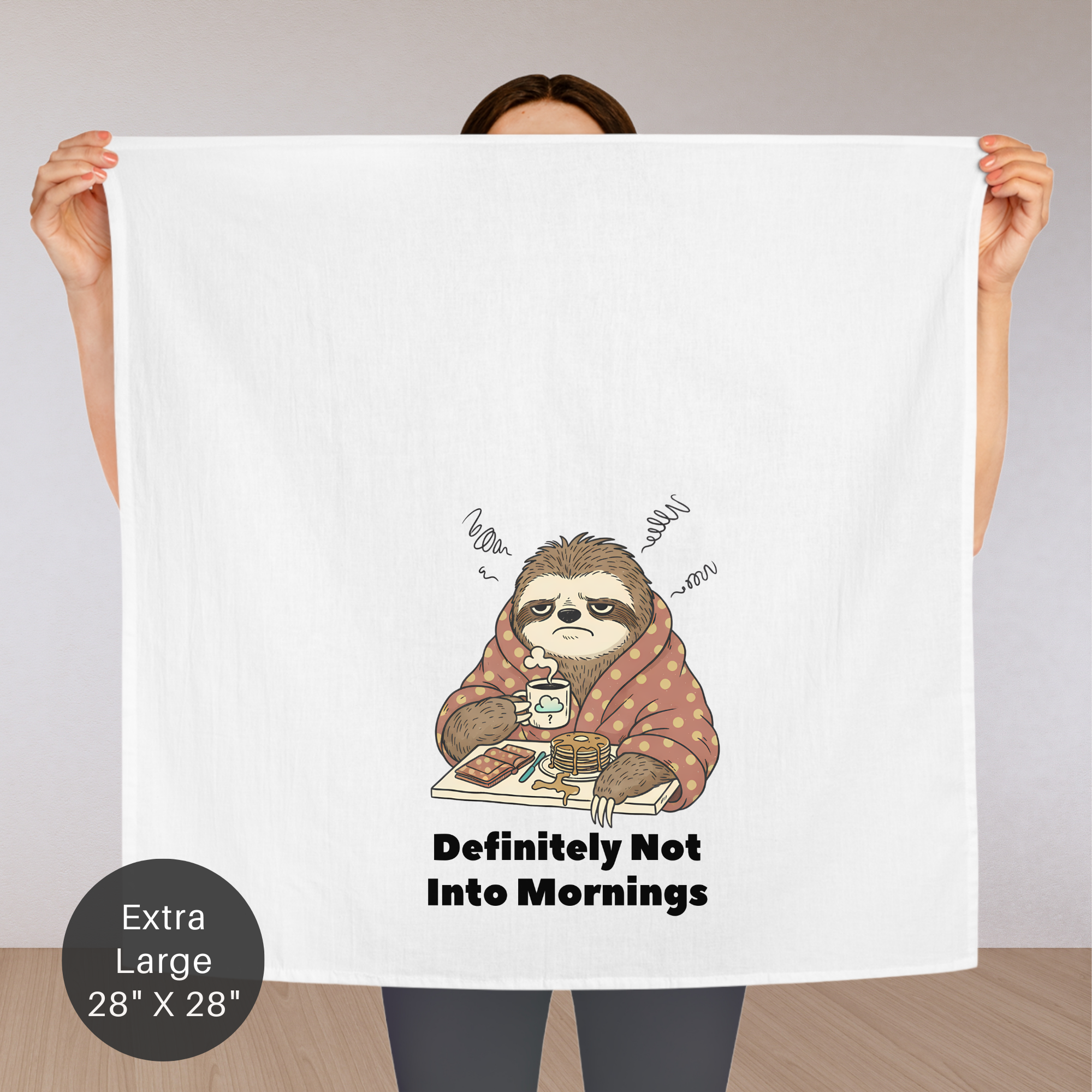 Person holding an extra large tea towel with a sloth illustration and text 'Definitely Not Into Mornings.