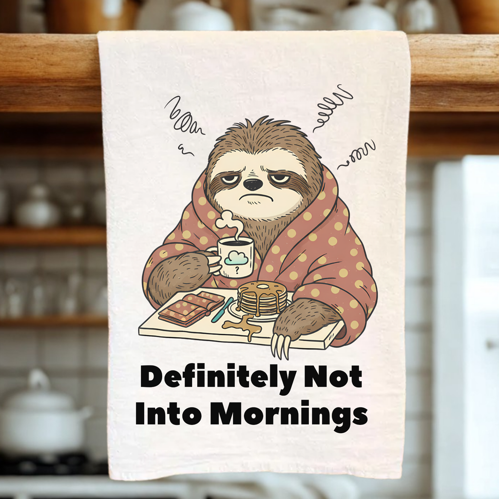 Tea towel with a sloth design and text 'Definitely Not Into Mornings' hanging on a wooden rack.