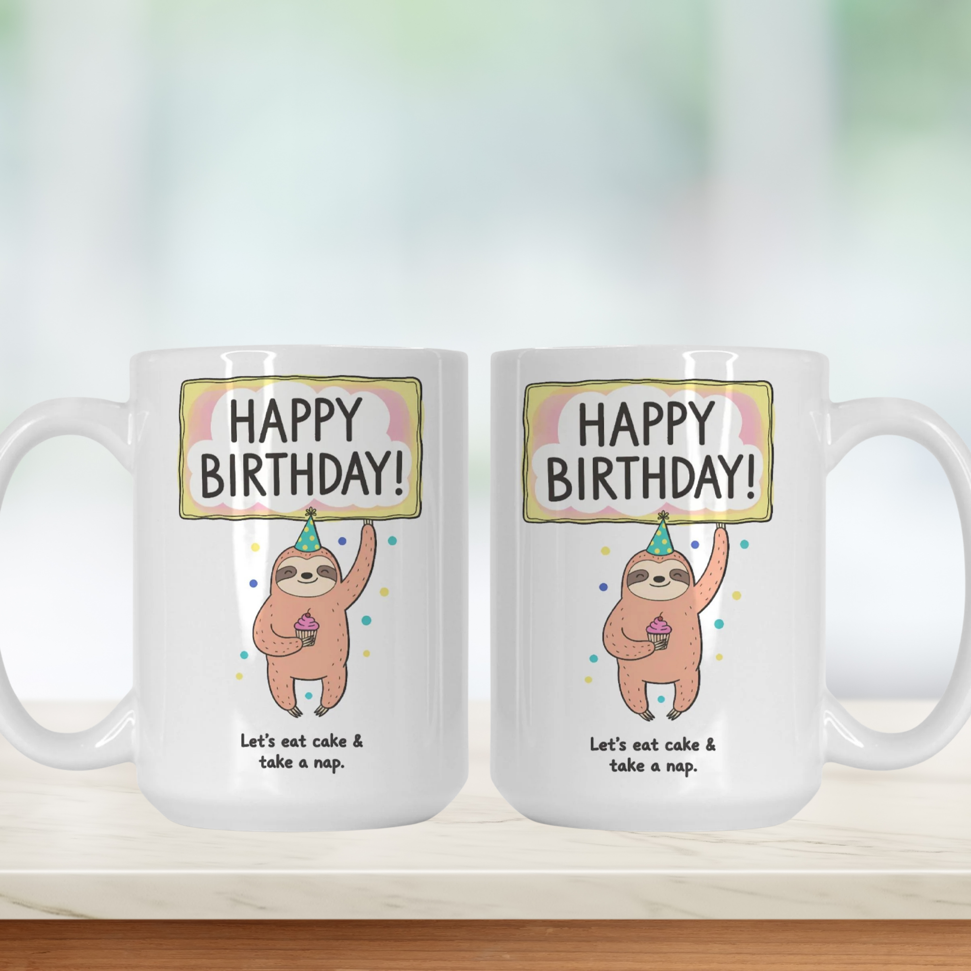Two white mugs with a sloth design and 'Happy Birthday!' text on a light background.