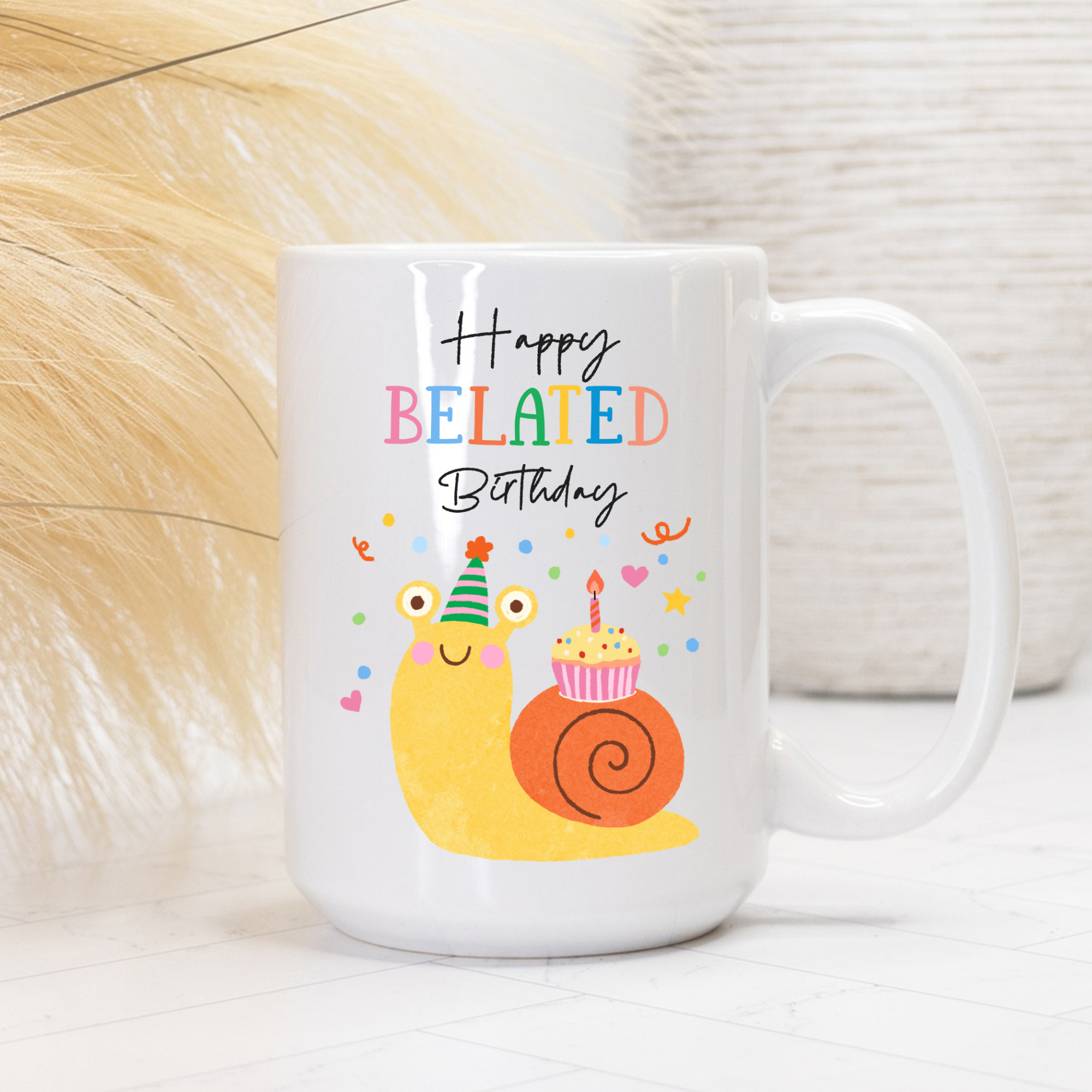 White 15oz. mug with a cartoon snail and 'Happy Belated Birthday' text on a white background