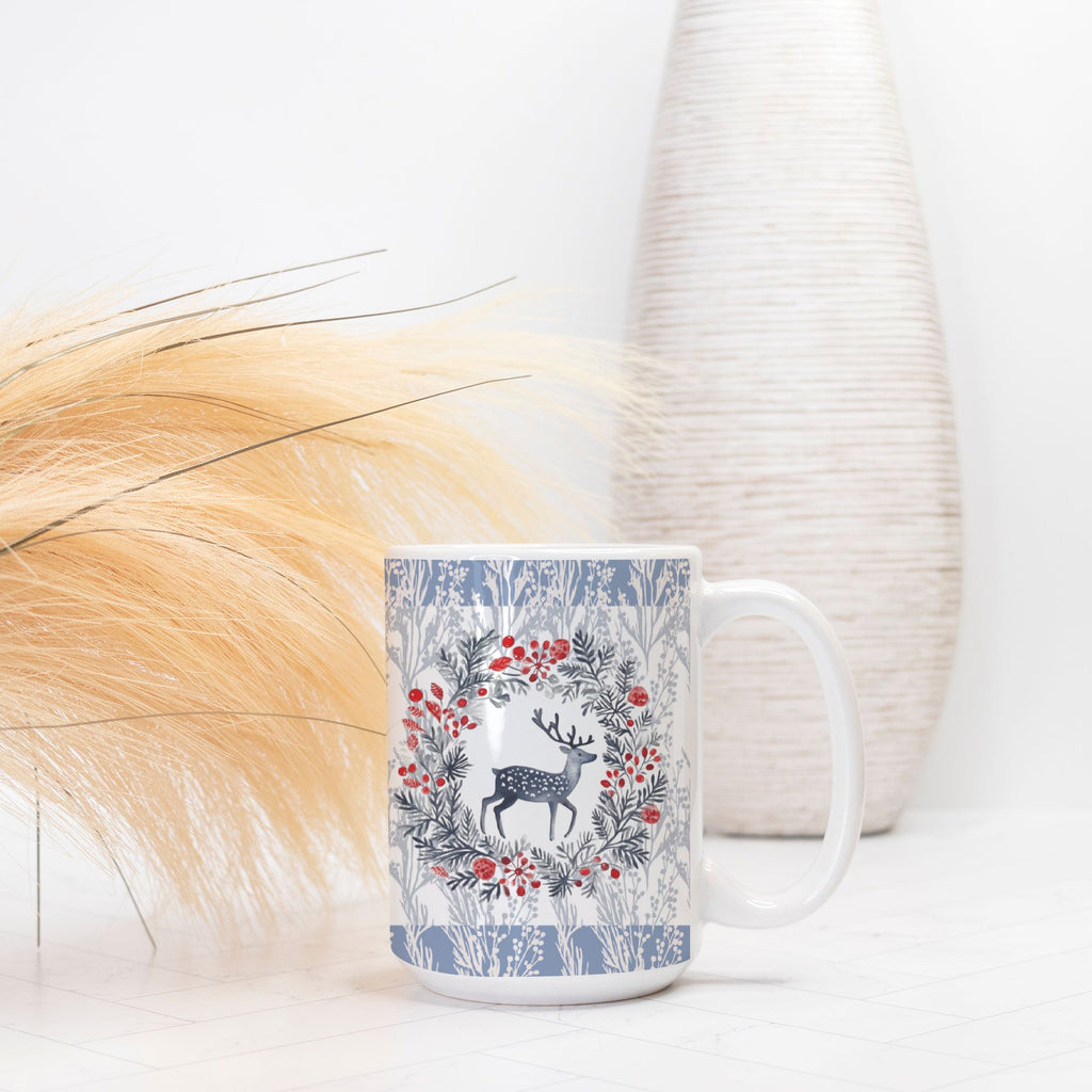 Mug with deer and floral design on a white surface with decorative elements