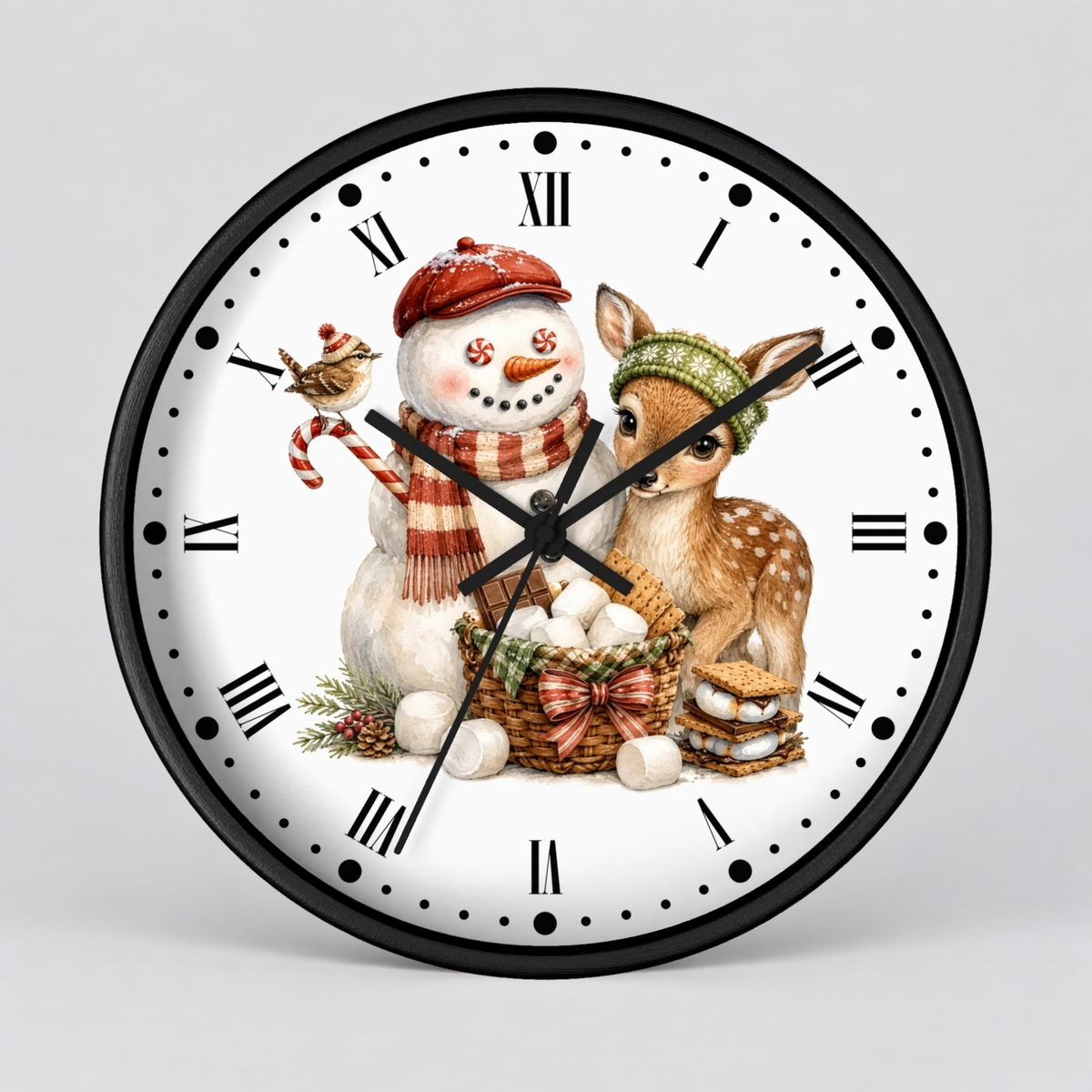 A round wall clock with a black frame and white face, featuring a winter holiday illustration of a snowman in a red hat and scarf, a deer in a green knit hat, marshmallows, and a bird, with black Roman numerals and hands on a light gray background.