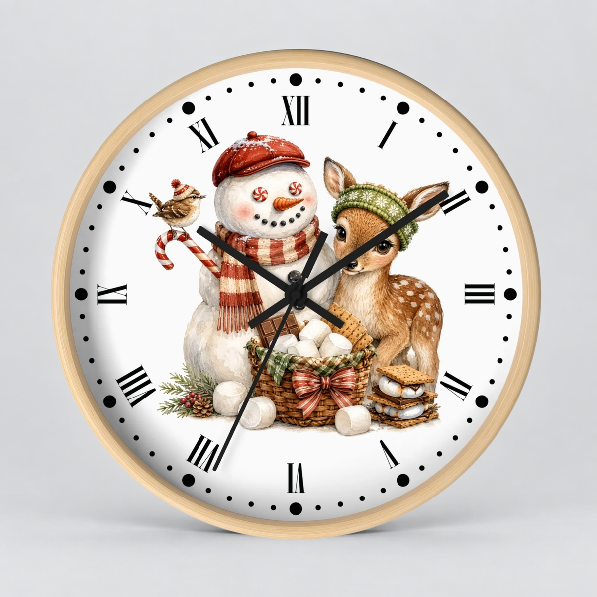 A round wall clock with a light wood frame and a white face, featuring a festive illustration of a snowman in a red hat and scarf, a deer wearing a green hat, a basket of eggs, and a bird. The clock has black Roman numerals and black hands, photographed against a neutral light gray background.